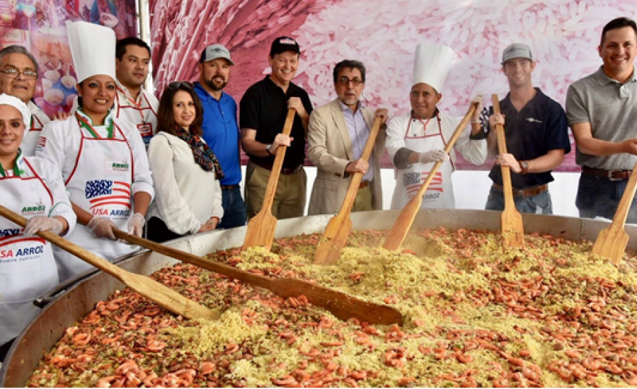 Chefs and people stirring a giant paella as part of a US rice promotion in Guatemala