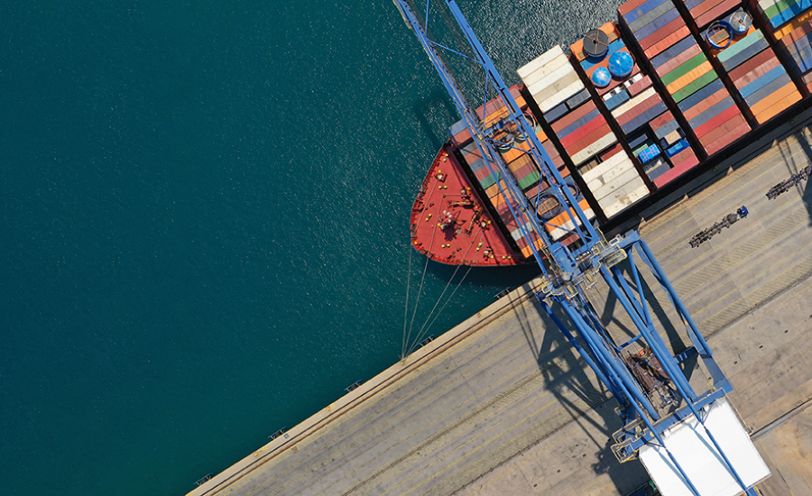 Image of a container ship being loaded at a dock