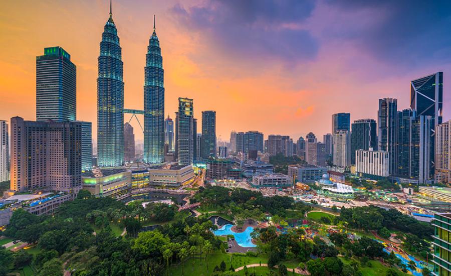 Kuala Lumpur, Malaysia skyline at dusk over the park.