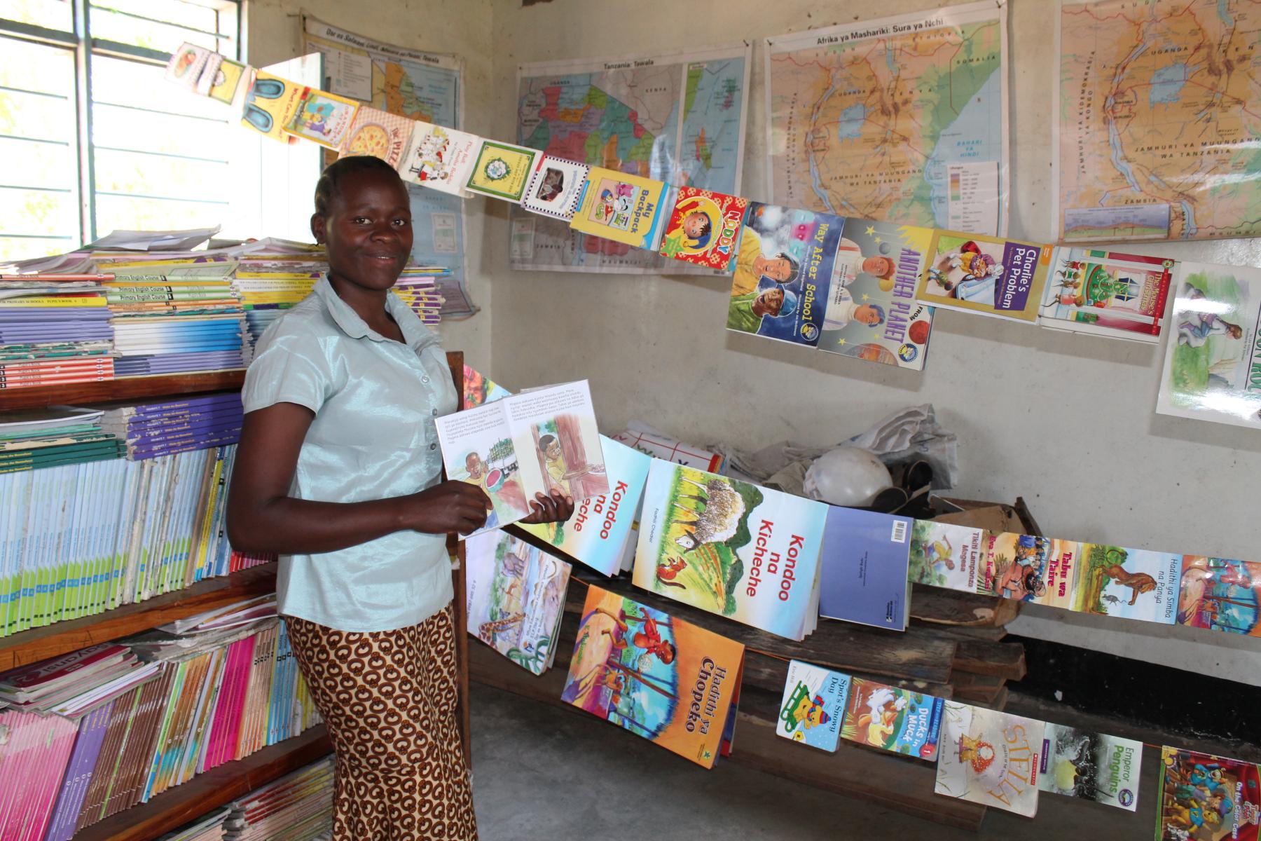 A teacher in the Mara region of Tanzania proudly shows her classroom full of learning resources in a reading-corner she created with help from PCI’s McGovern-Dole program. The program is more than a school feeding program, it also helps feed students’ app